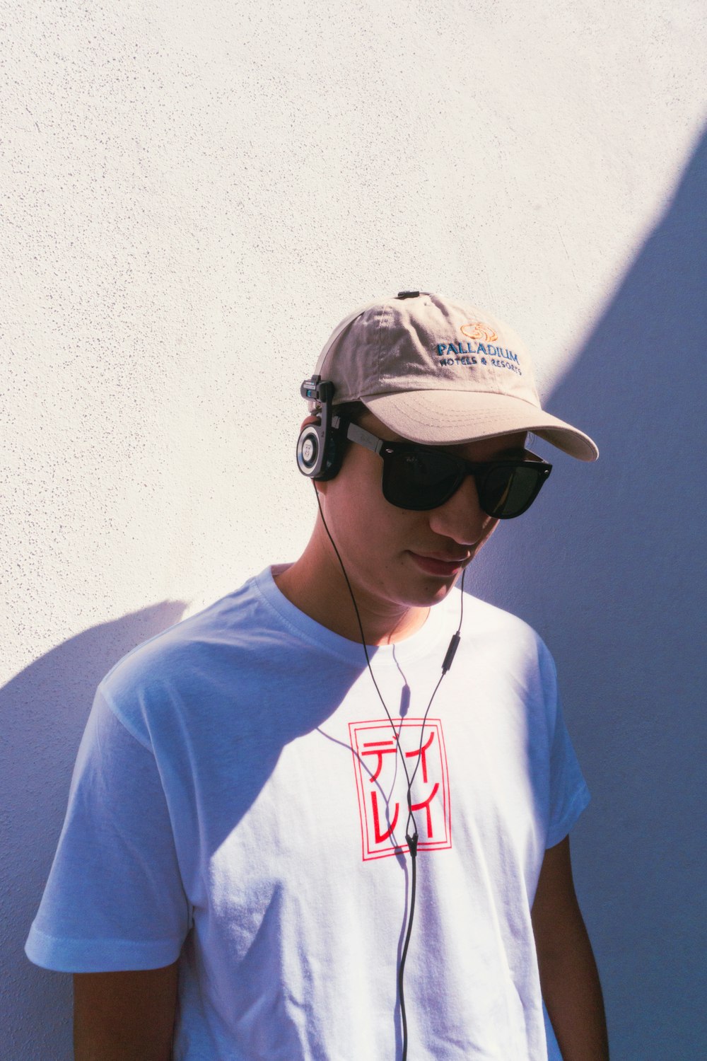 a young man wearing headphones and a hat