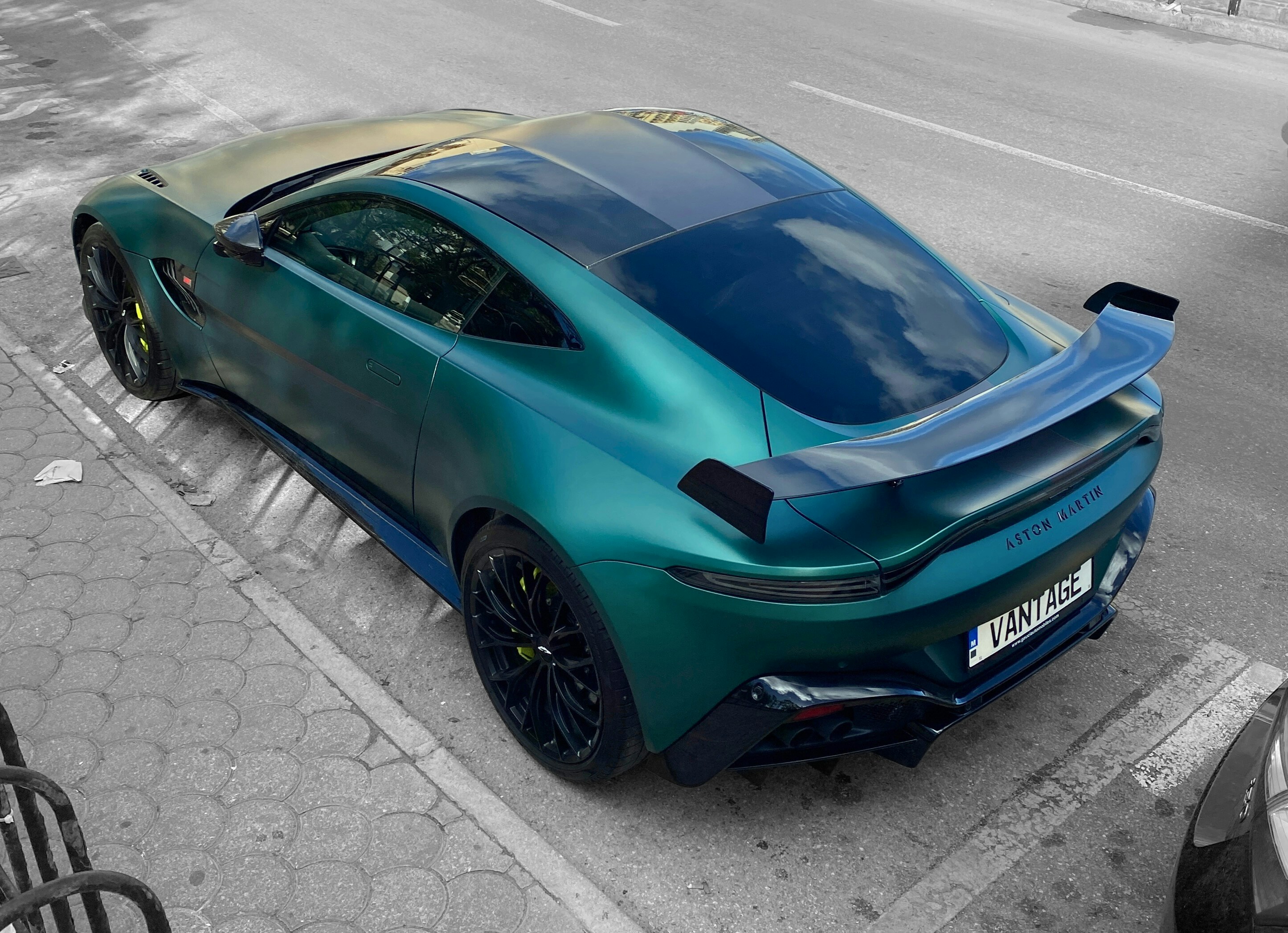 A blue sports car parked along a road, illustrating transport options.