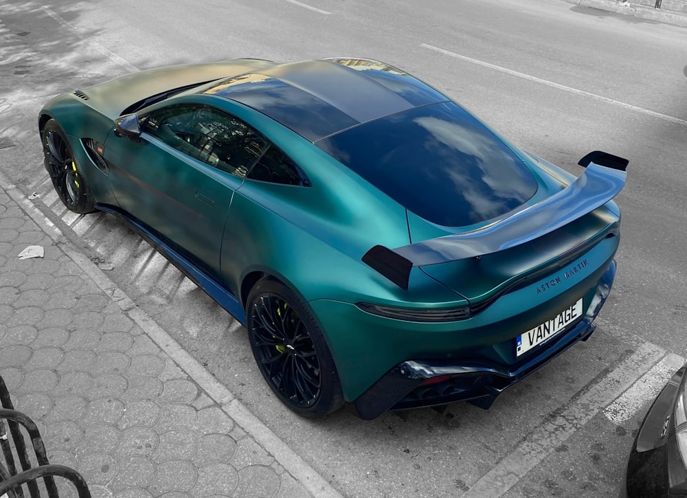 a blue sports car parked on the side of the road