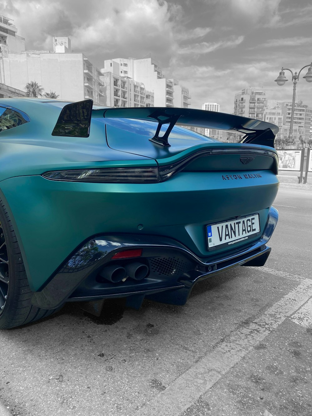 a blue sports car parked on the side of the road