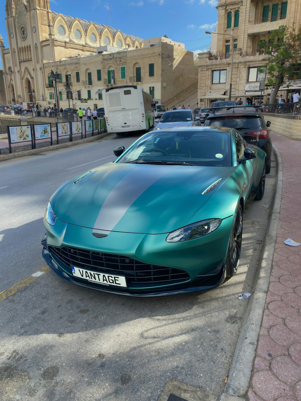 a green sports car parked on the side of the road