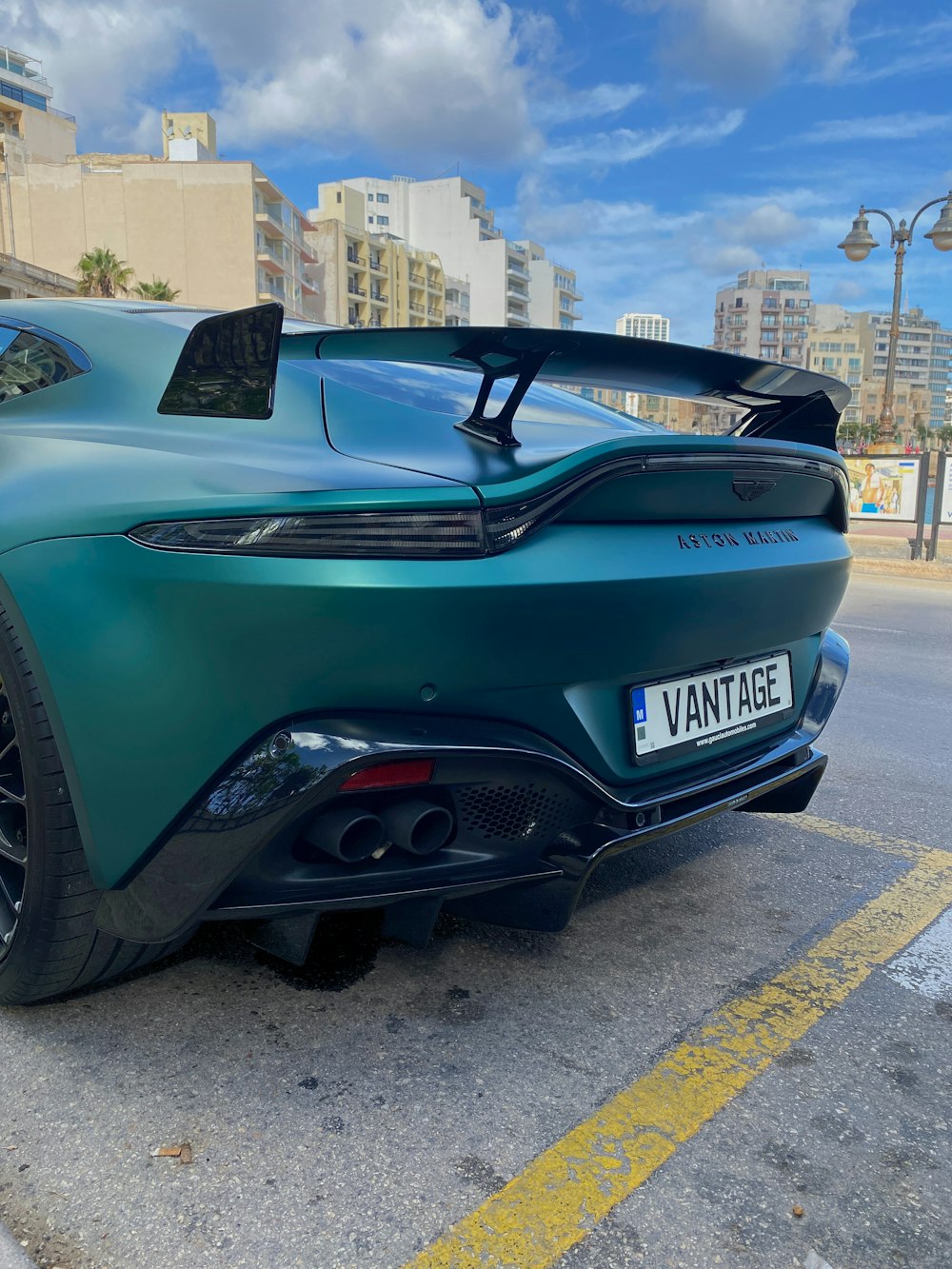 a green sports car parked on the side of the road