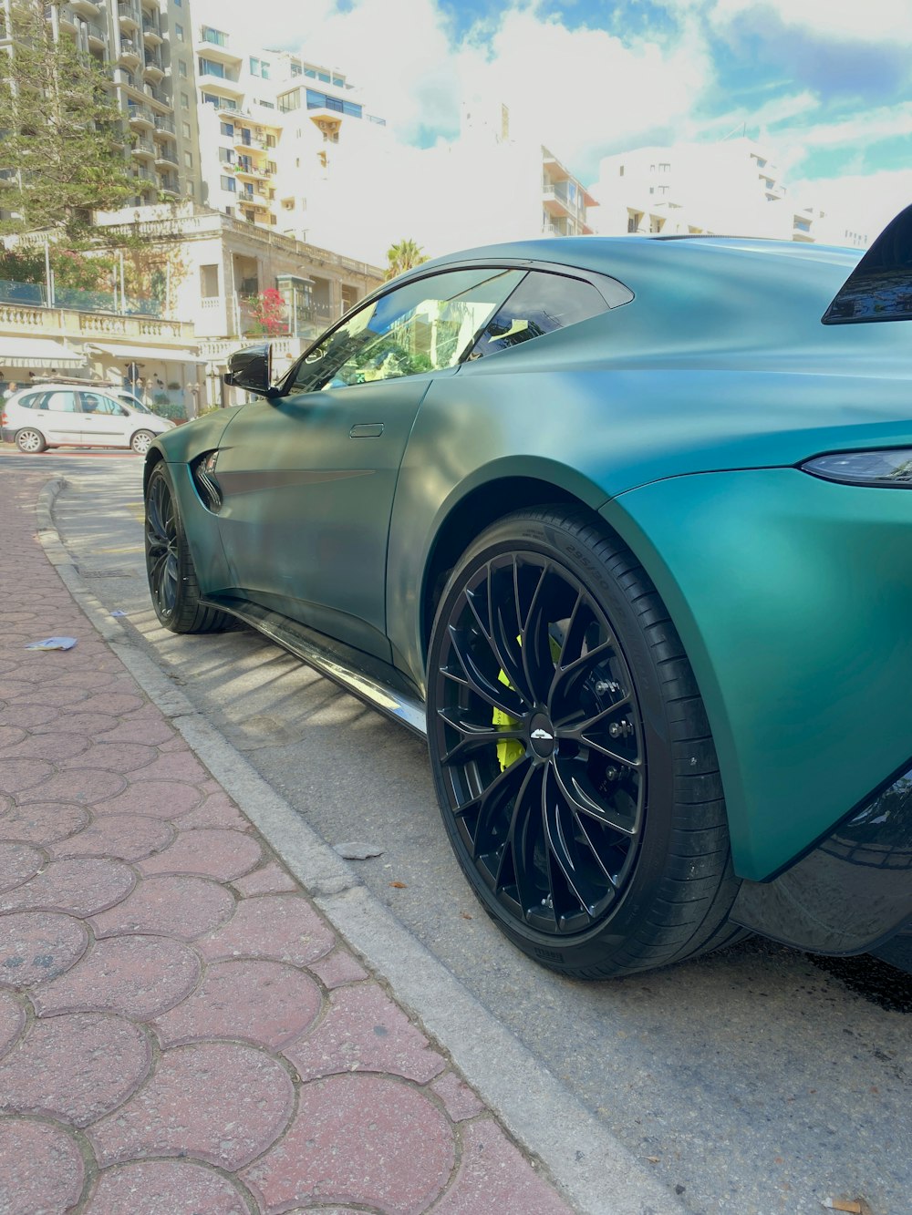 a blue sports car parked on the side of the road