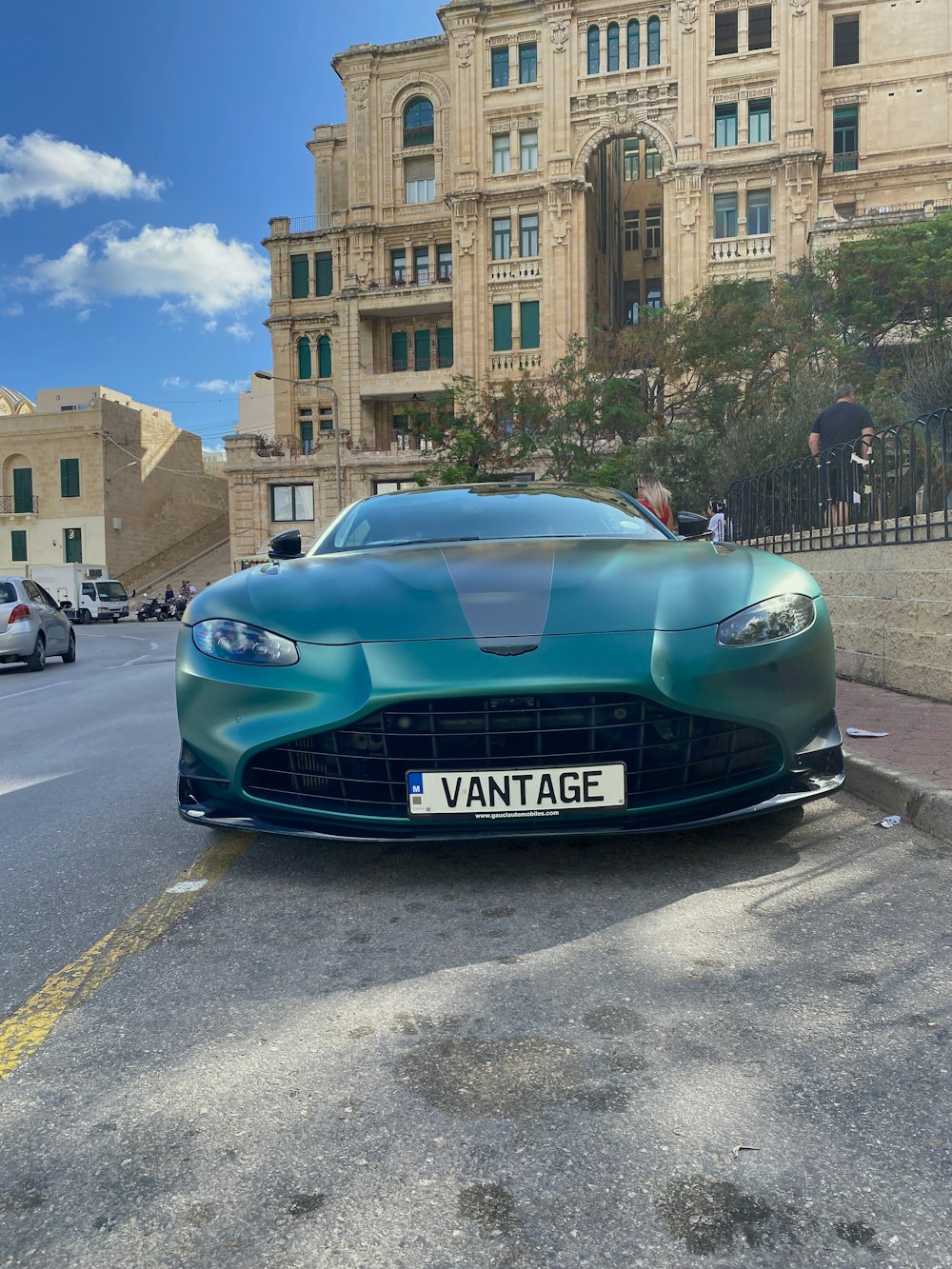 a blue sports car parked on the side of the road