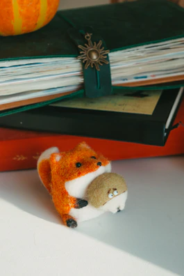 A happy family unwrapping a package containing a handcrafted fabric fox doll