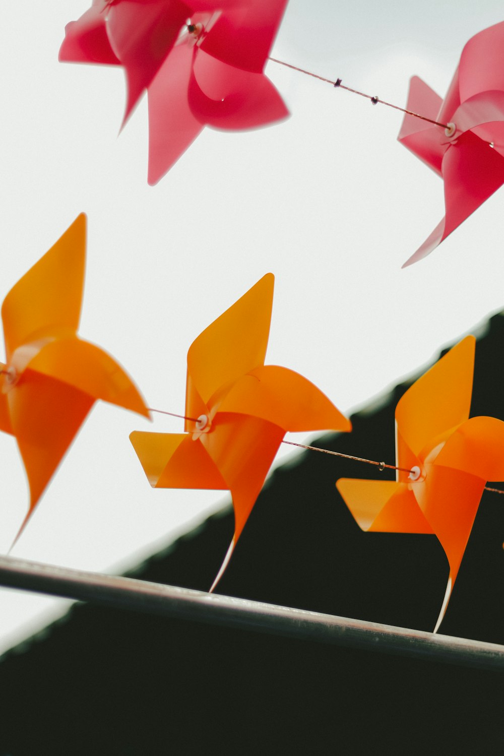 a group of red and orange paper flowers