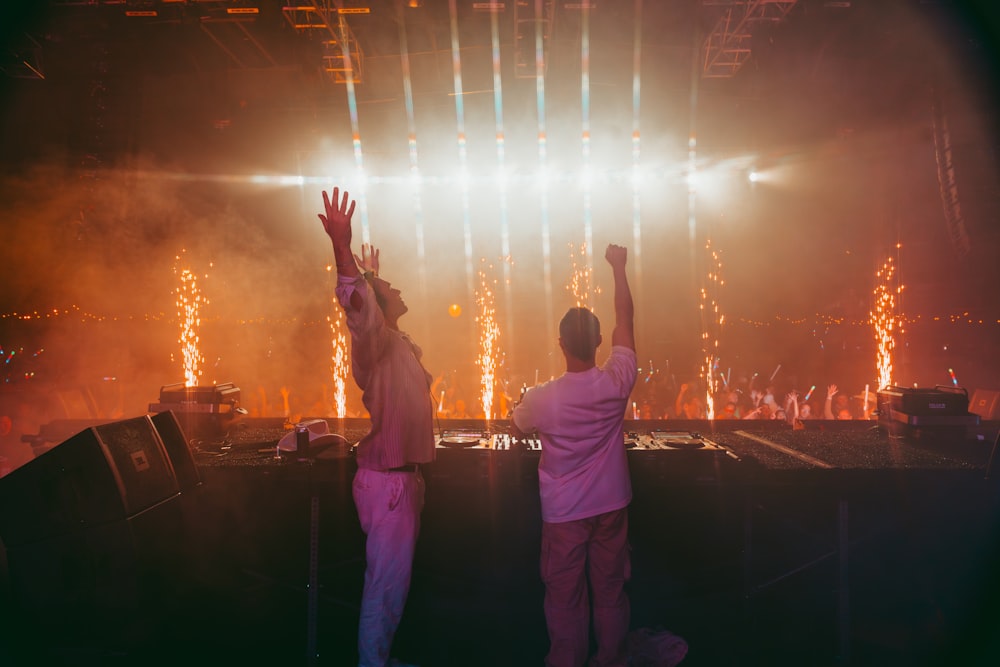 a couple of men standing on top of a stage