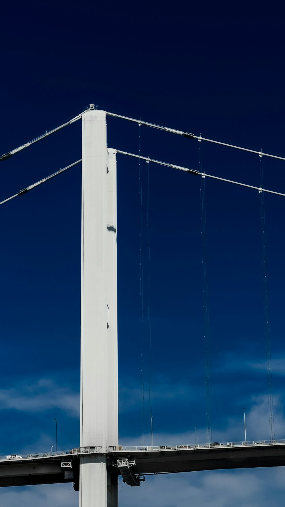 a tall white pole with a street light on top of it