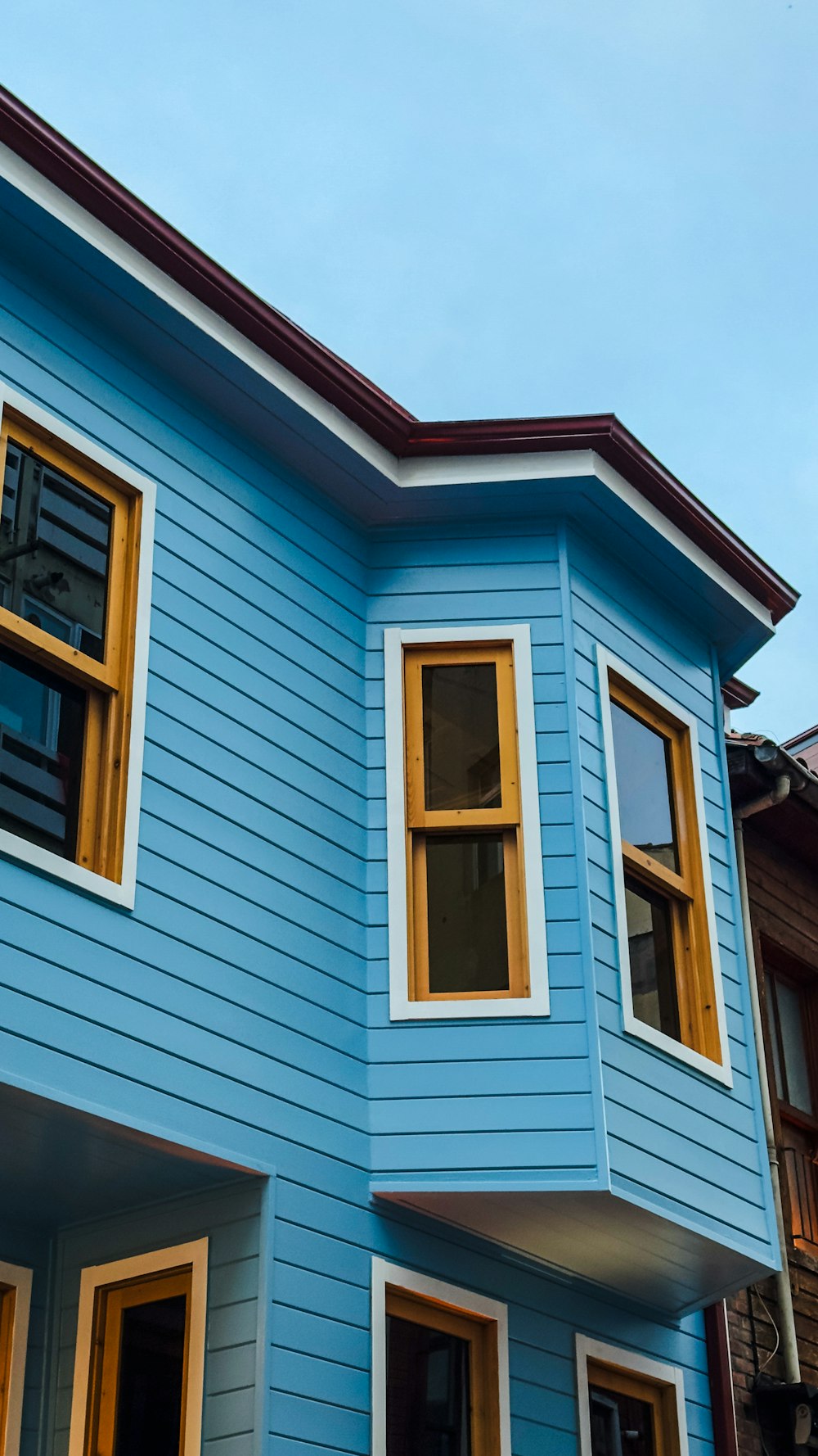 a blue house with a clock on the front of it