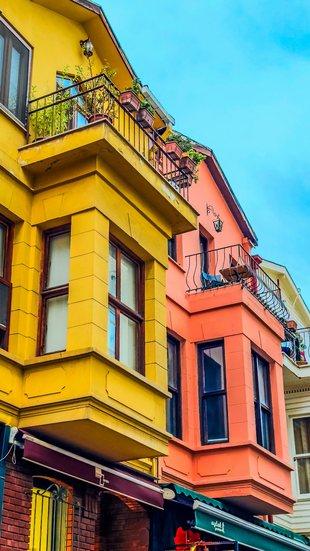 a row of multicolored buildings on a city street