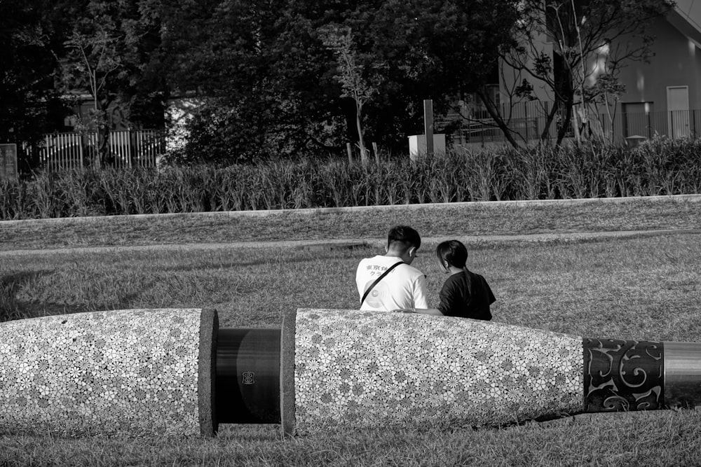 a couple of people that are standing in the grass