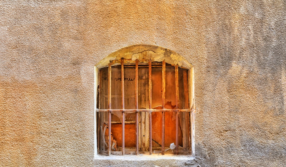 a window with bars on the side of a building