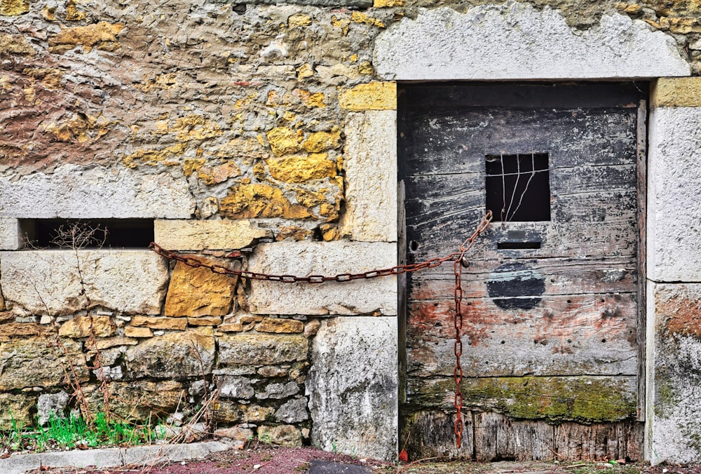 an old door with a chain on the outside of it