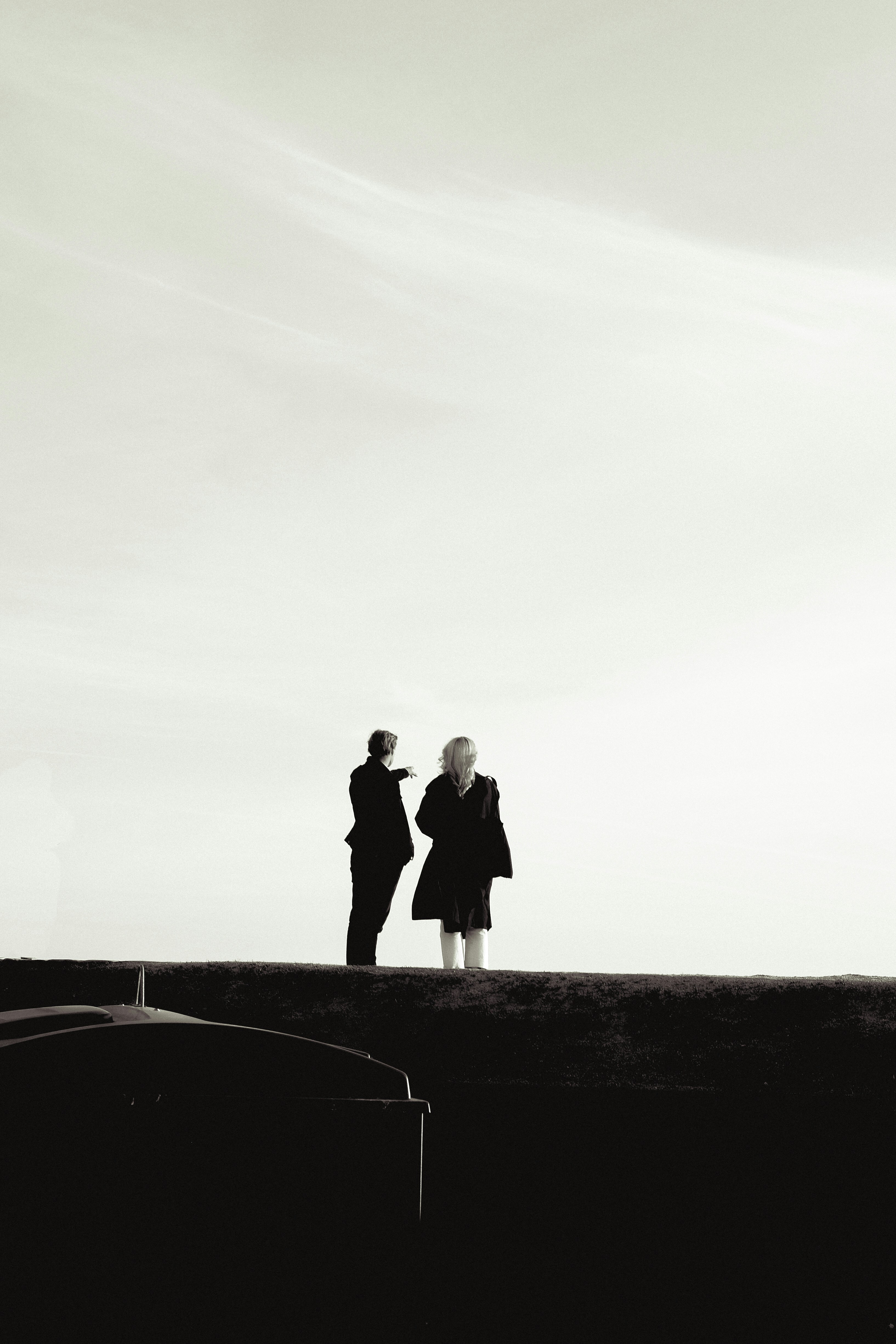A couple of people standing on top of a hill photo – Free Helsinki ...