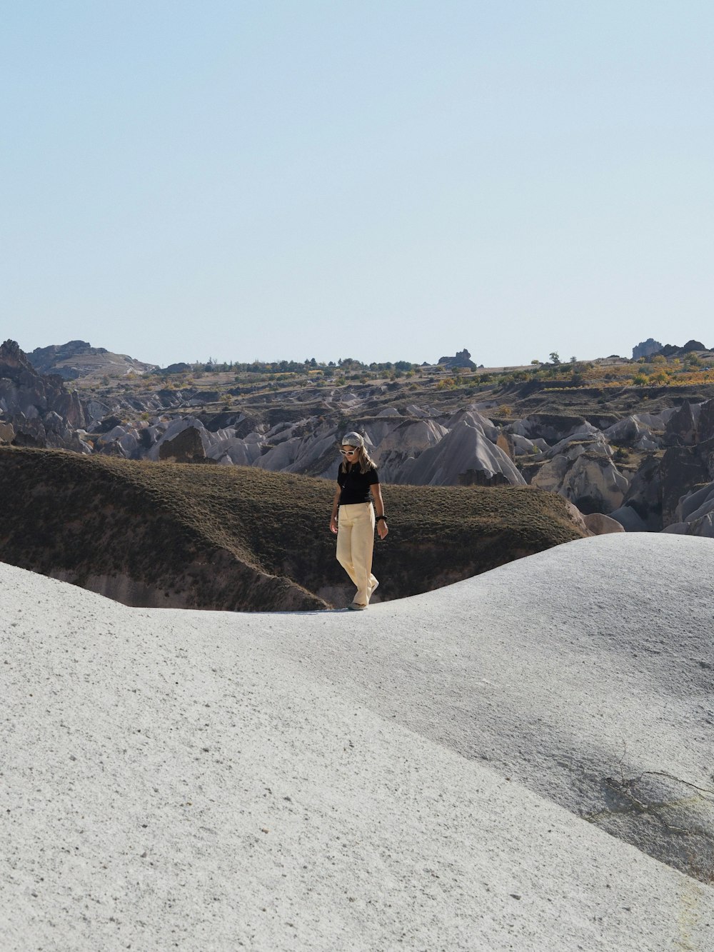 a person walking up a hill with a surfboard