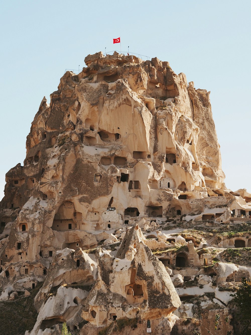 a rock formation with a flag on top of it