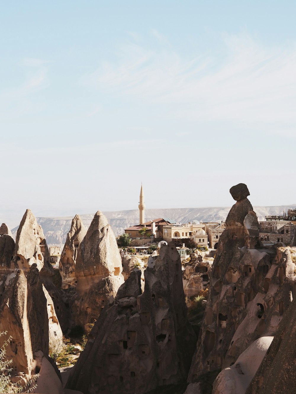 a rocky landscape with a small village in the distance