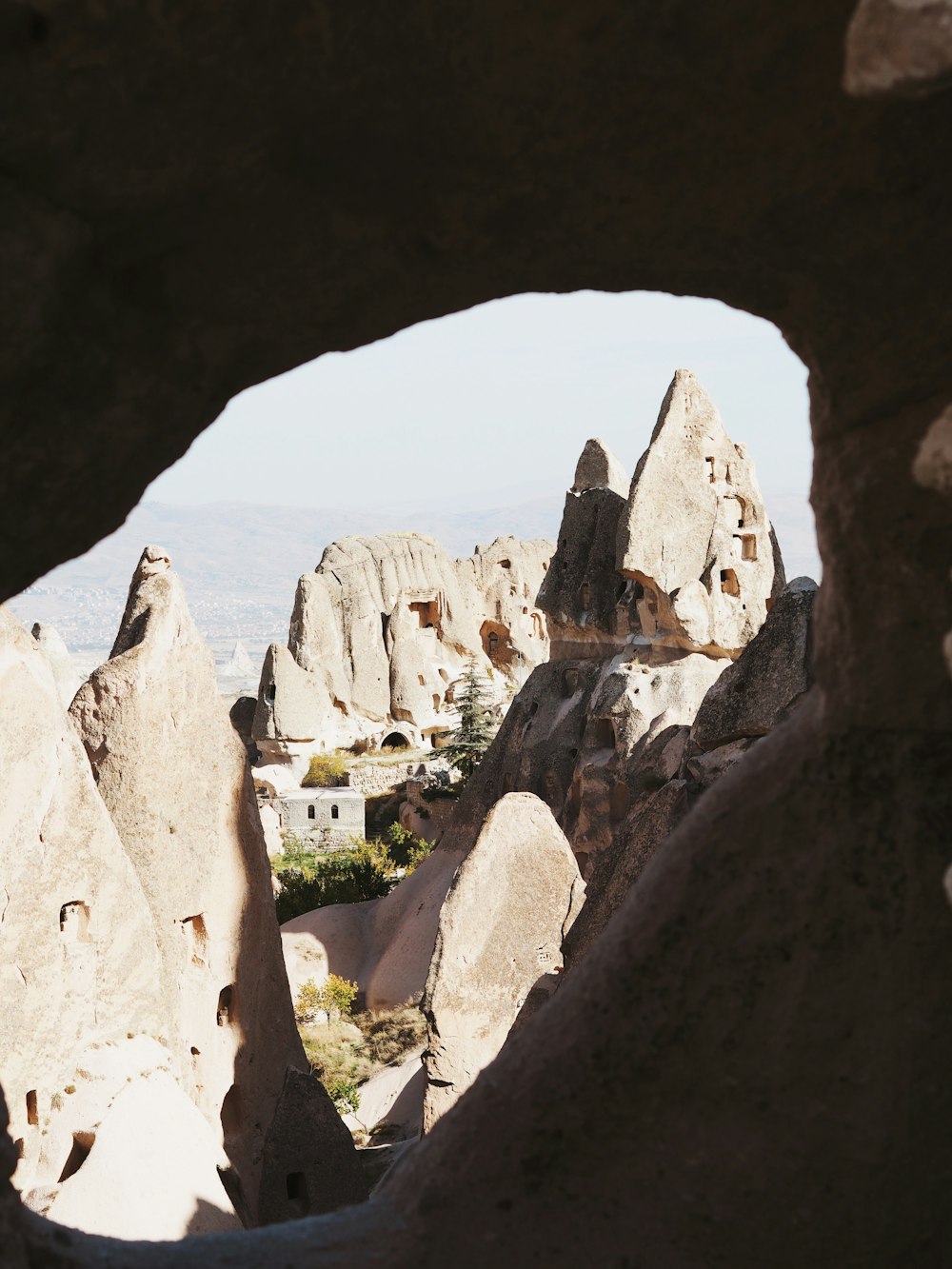 a view through a hole in a rock formation