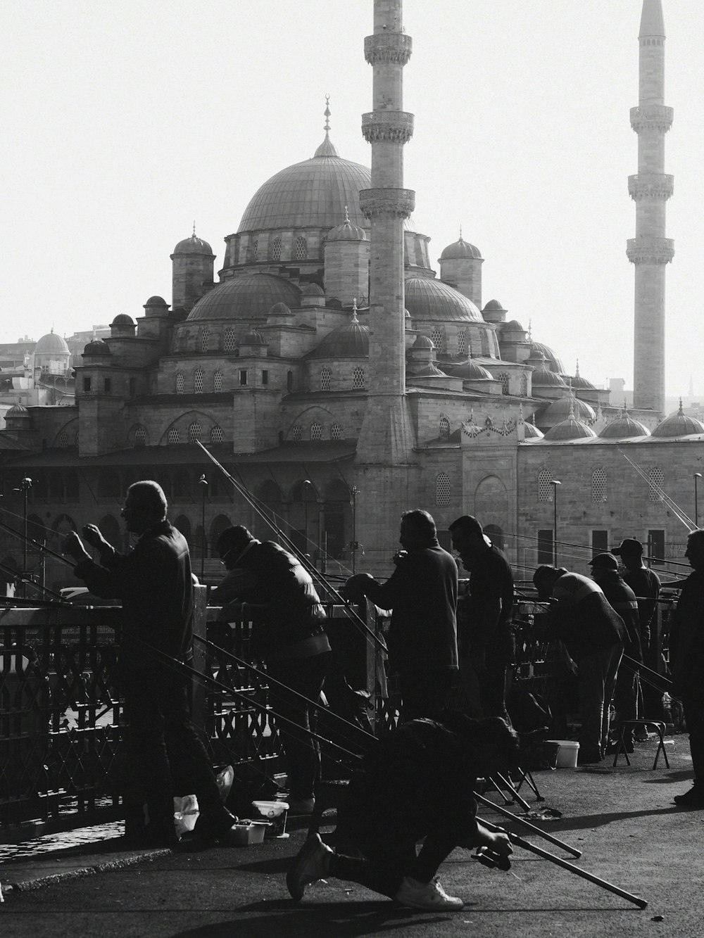 a black and white photo of people in front of a building