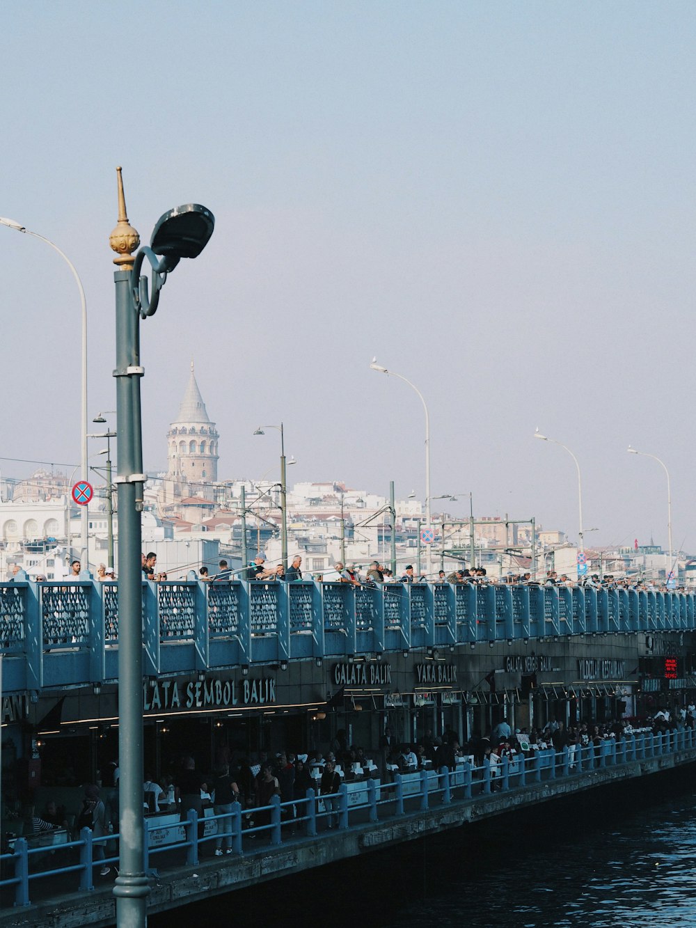 a street light next to a body of water