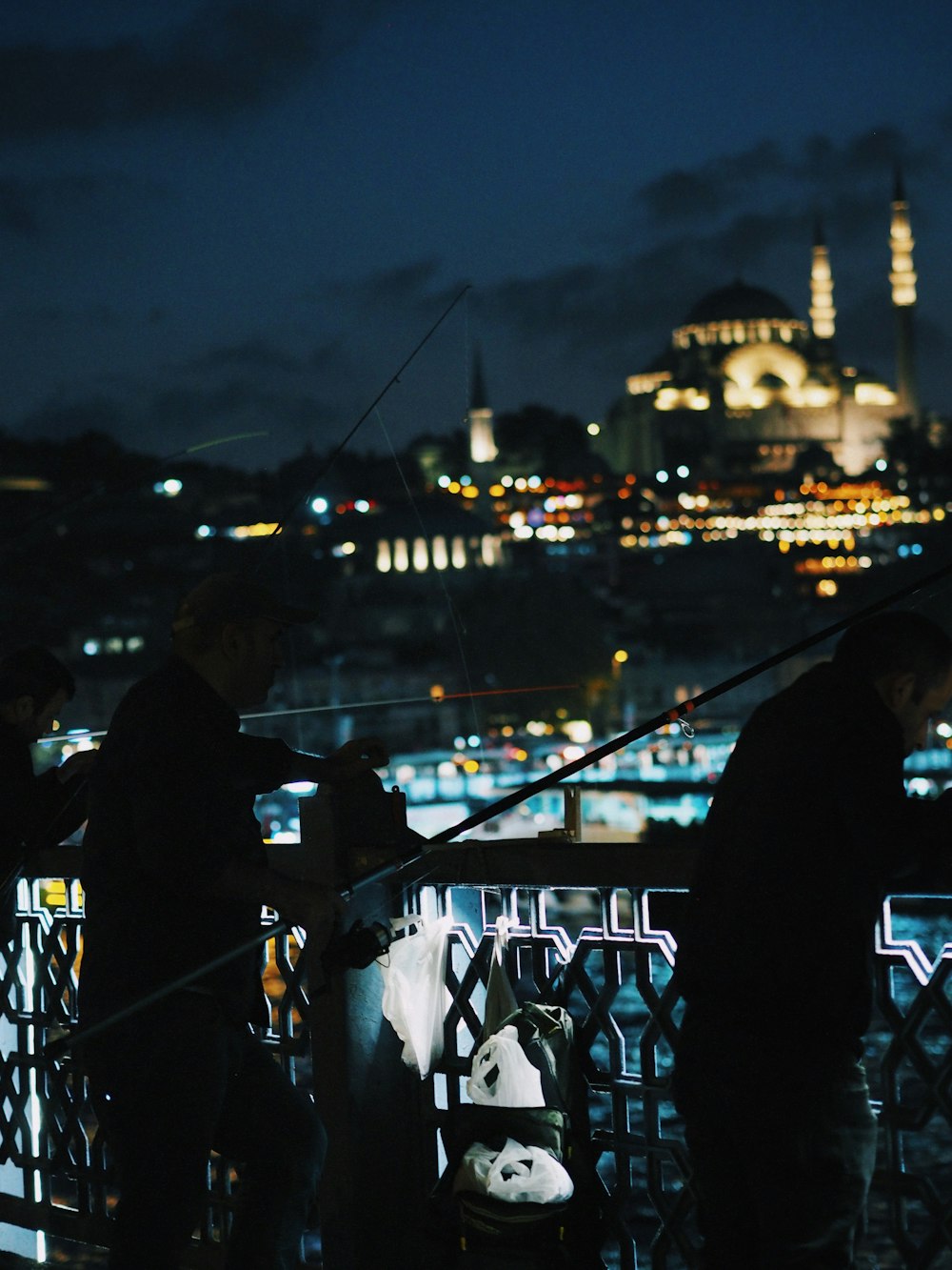 a group of people standing on top of a bridge