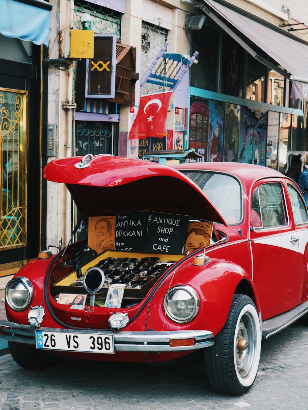 a red car parked on the side of a street