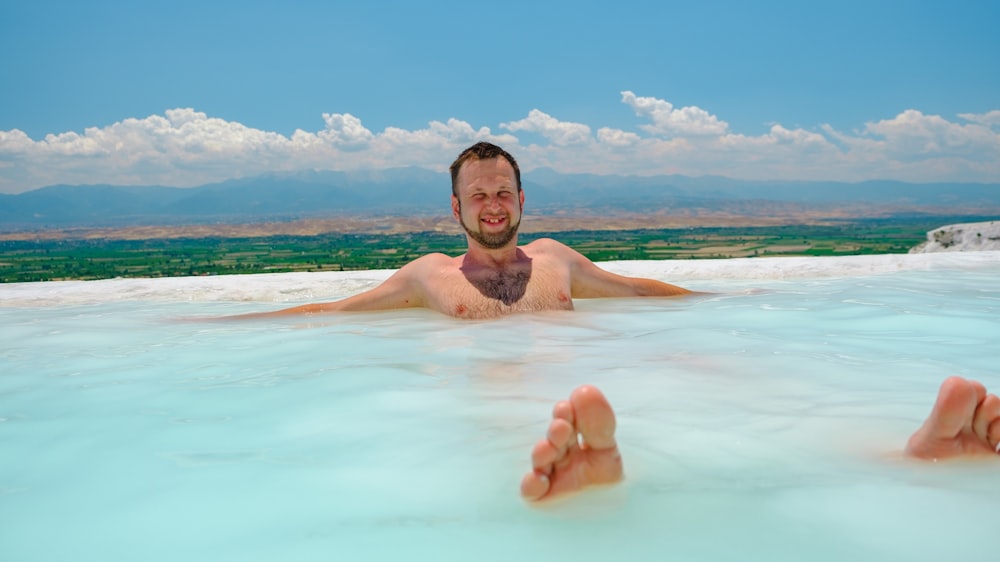 a man laying in a large pool of water