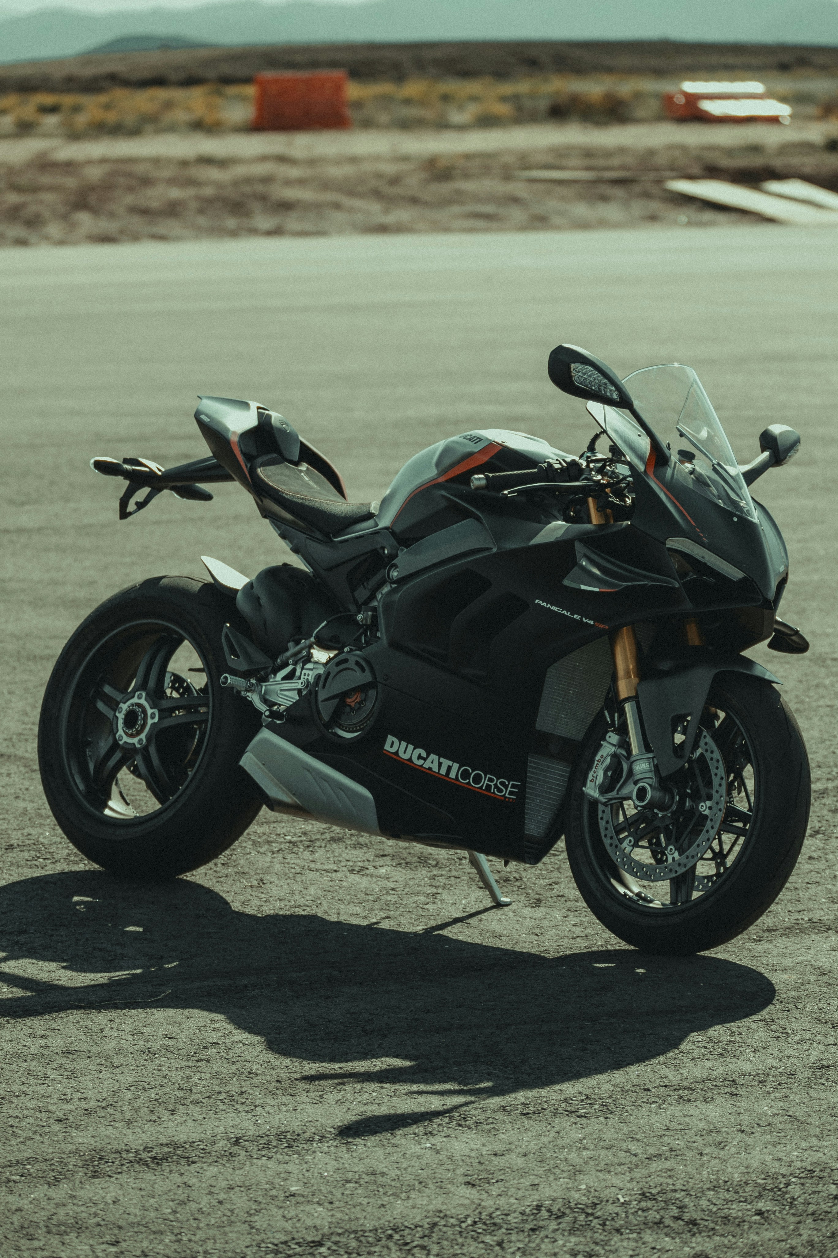 a black motorcycle parked in a parking lot