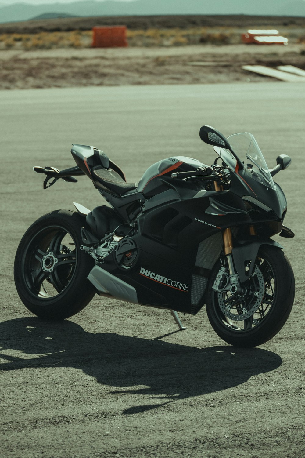 a black motorcycle parked in a parking lot