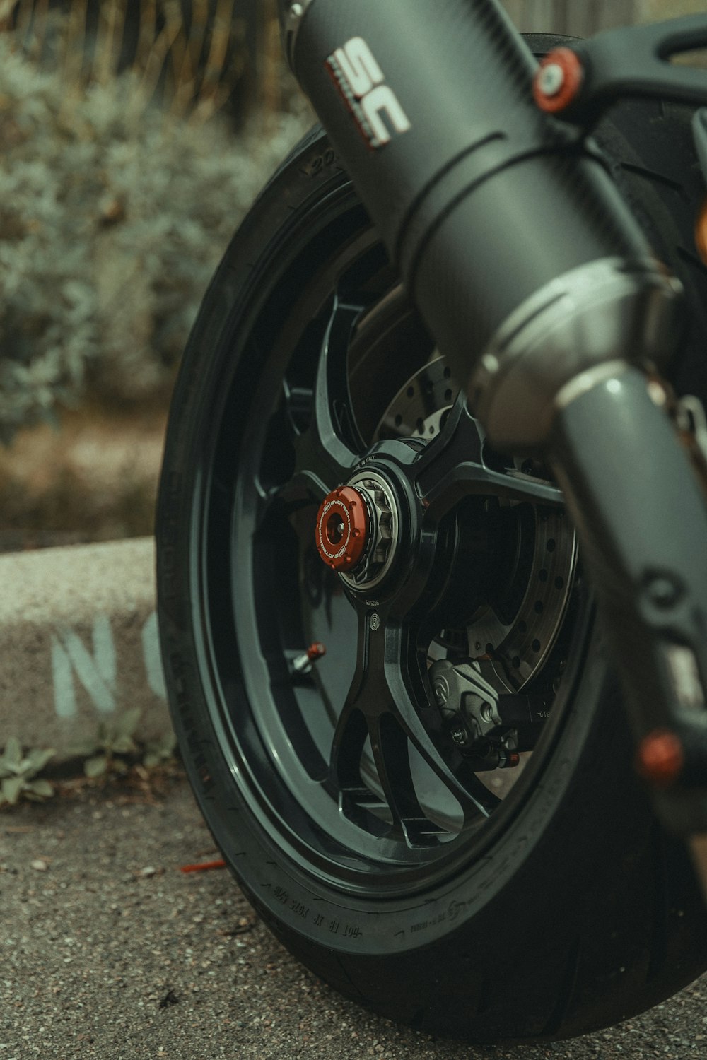a close up of a motorcycle wheel on the ground