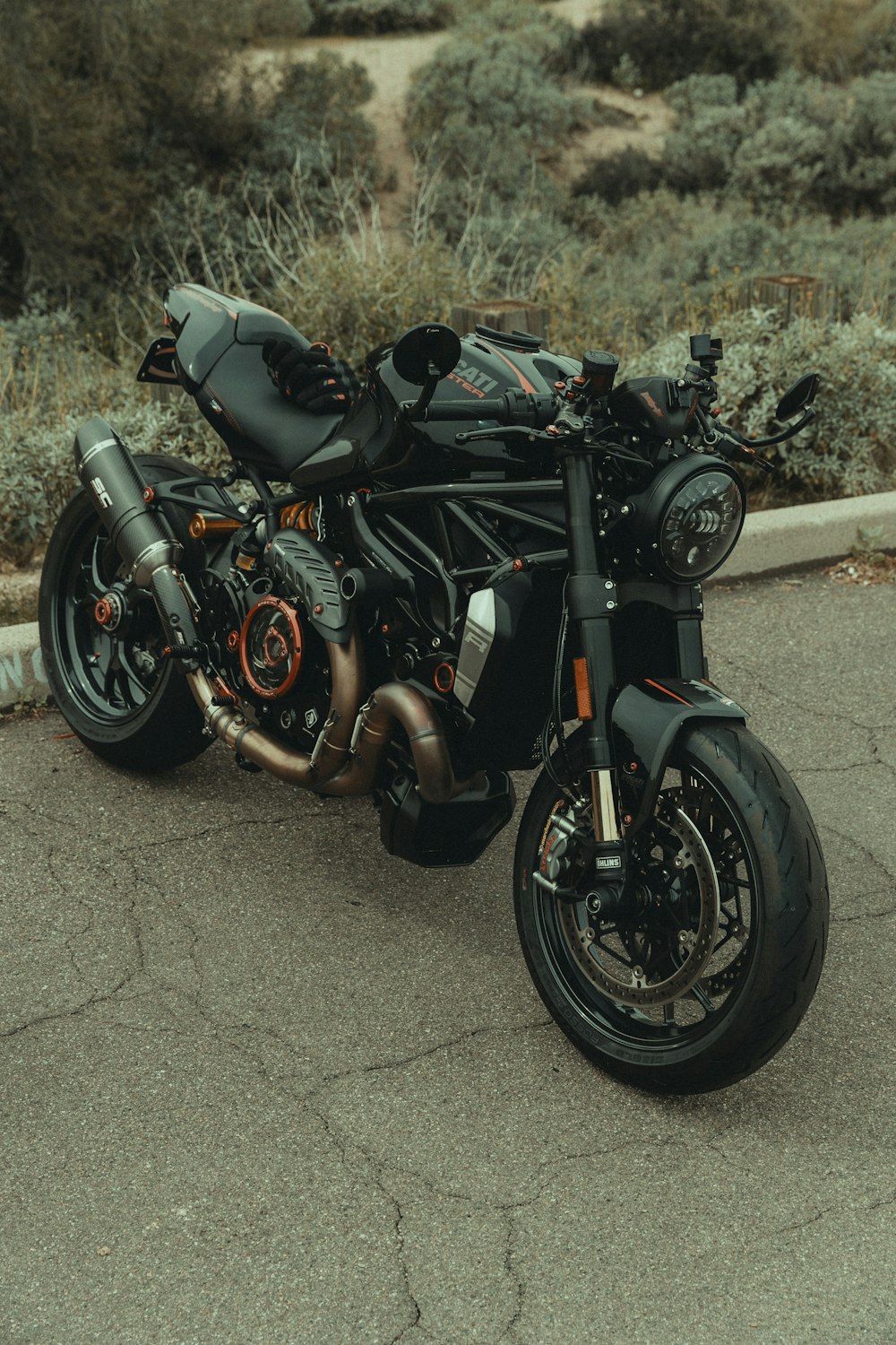 a black motorcycle parked on the side of the road