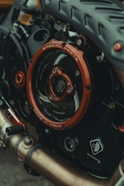 Close-up view of a motorcycle engine with a focus on the detailed components and branding. The metallic parts, including a prominently featured red circle marked with 'Special Parts' and 'Made in Italy', are contrasted with dark mechanical textures. Various elements like pipes and gears exhibit intricate design, reflecting craftsmanship and engineering.