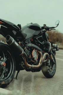A motorcycle on the road with a Suaranusa exhaust, emphasizing the sound and performance.