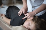 a woman getting a back massage from a massager