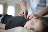 a woman getting a massage from a man in a white shirt