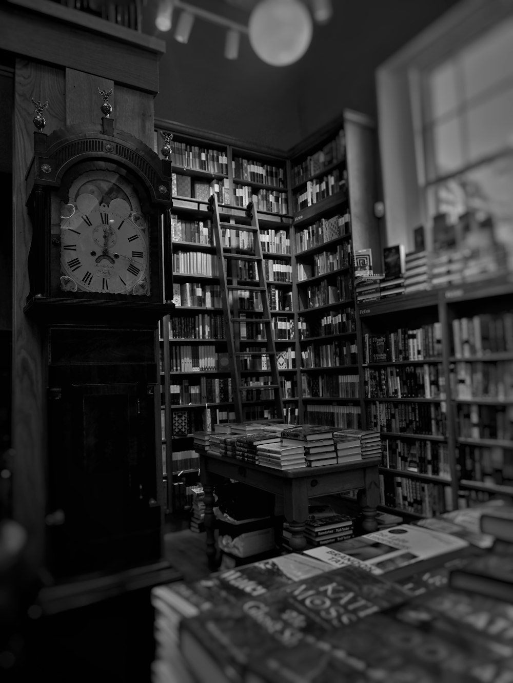 a clock sitting in the middle of a library filled with books
