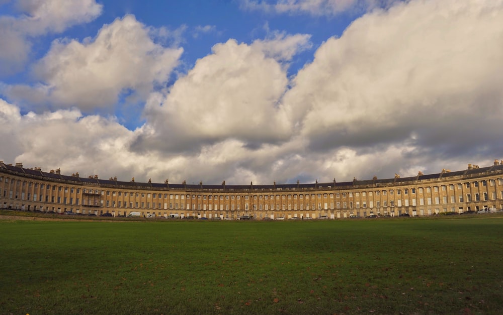 a large building sitting on top of a lush green field