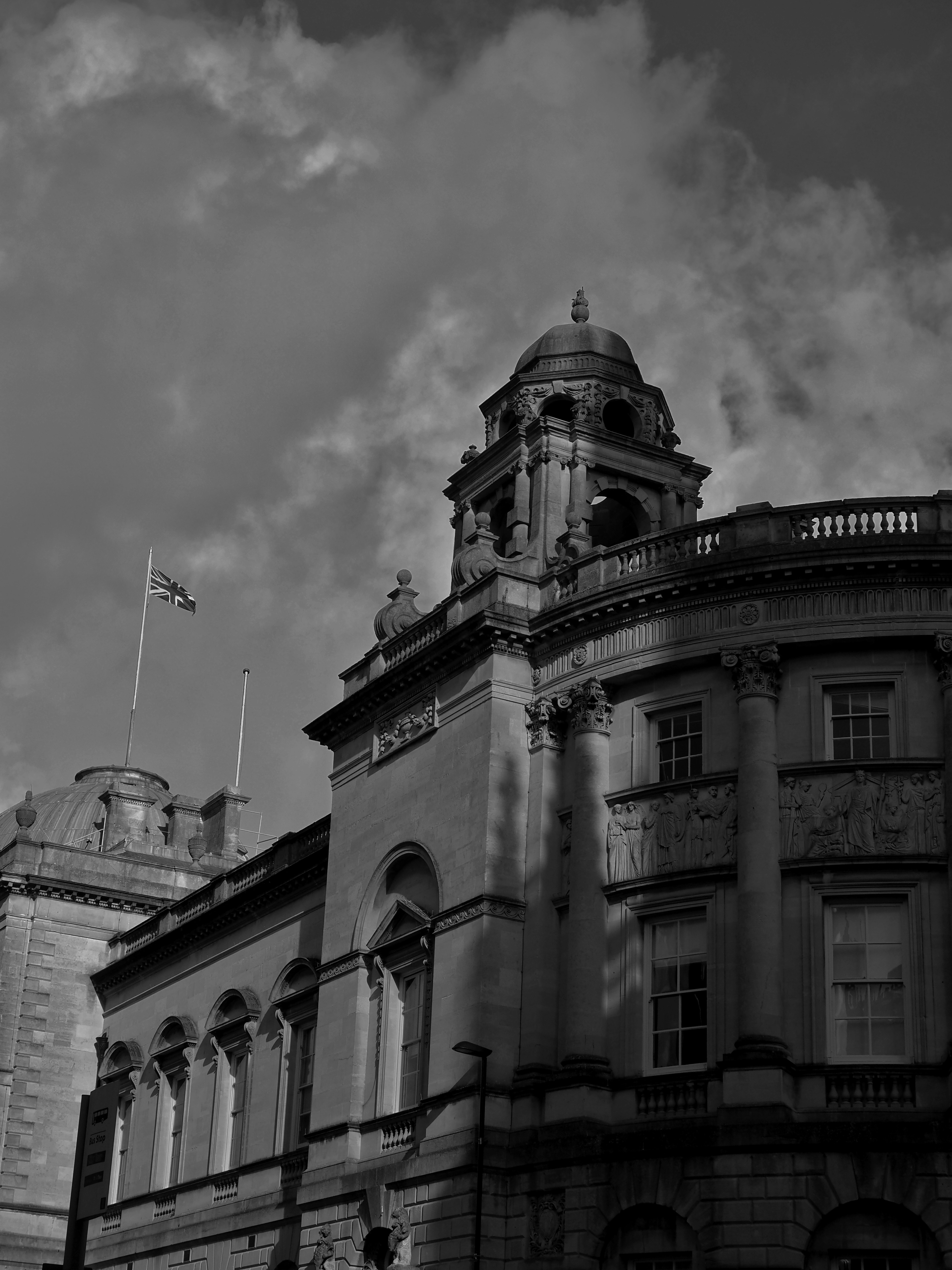 a black and white photo of a building with a clock tower