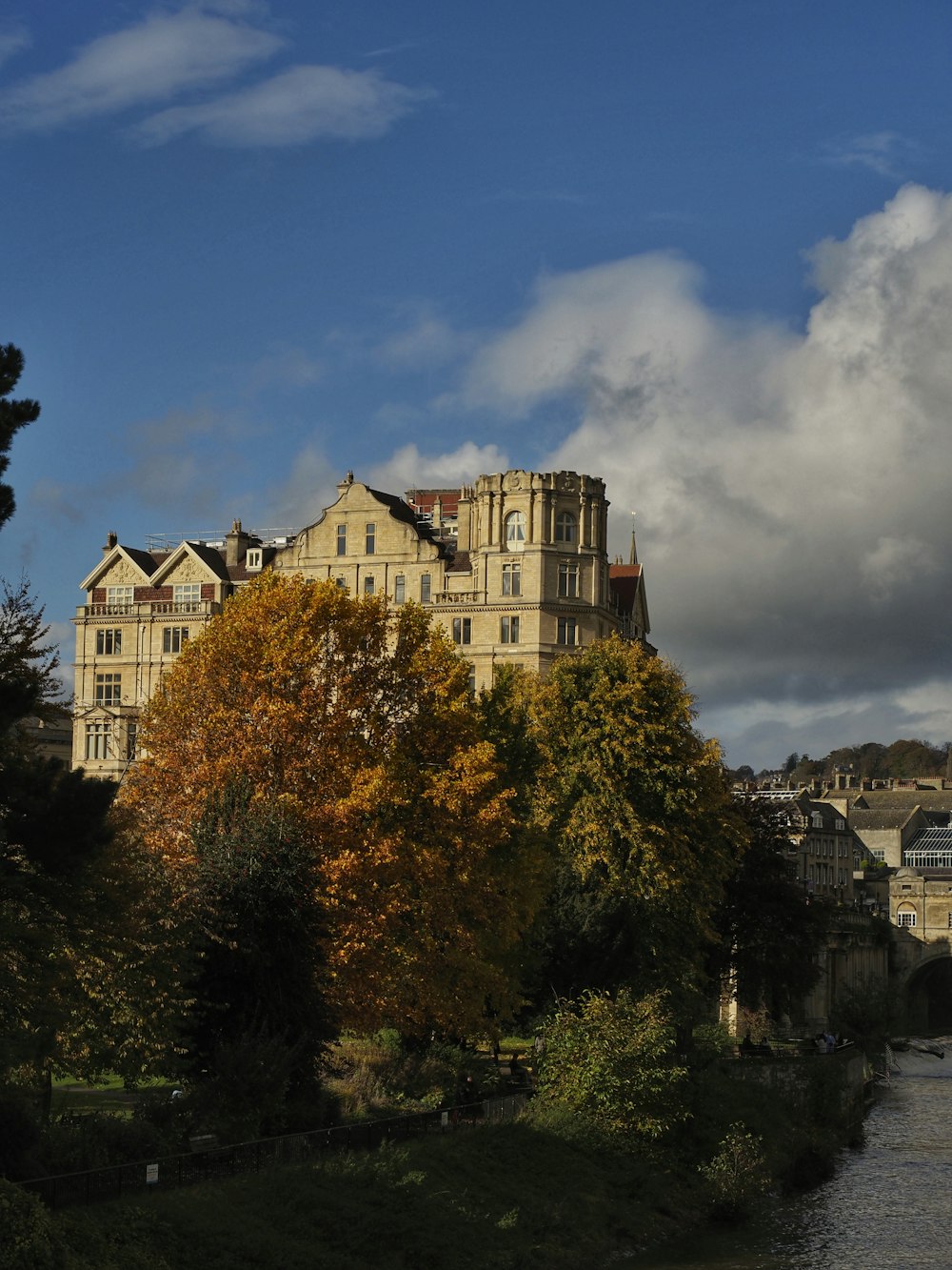 a large building sitting on top of a lush green hillside