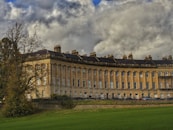 a large building sitting on top of a lush green field