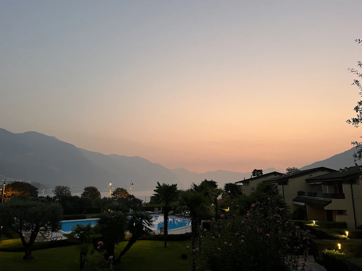 A serene private pool villa at sunset in Da Nang with lush greenery surrounding.