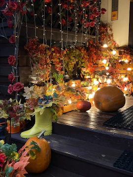 A cozy front porch decorated with autumn leaves and warm lights.