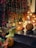 A beautifully decorated porch with colorful fall decorations and warm lighting.