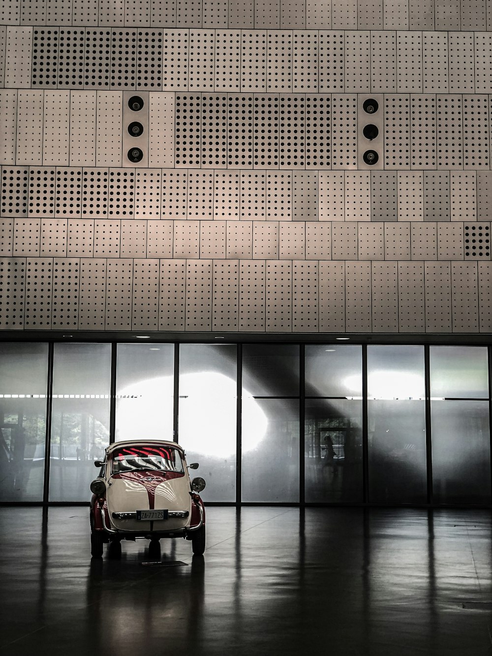 a small car parked in front of a building