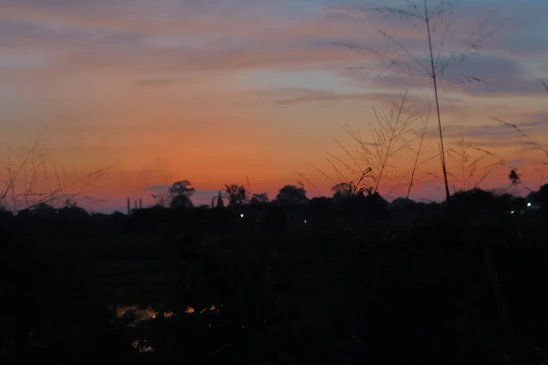 A serene Nairobi landscape at sunset with soft blue and orange hues reflecting calm and hope.