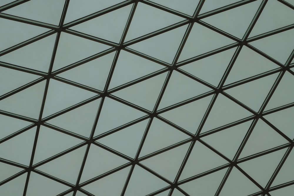 a close up of a metal structure with a sky background