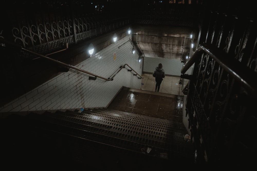 a person walking down a set of stairs at night