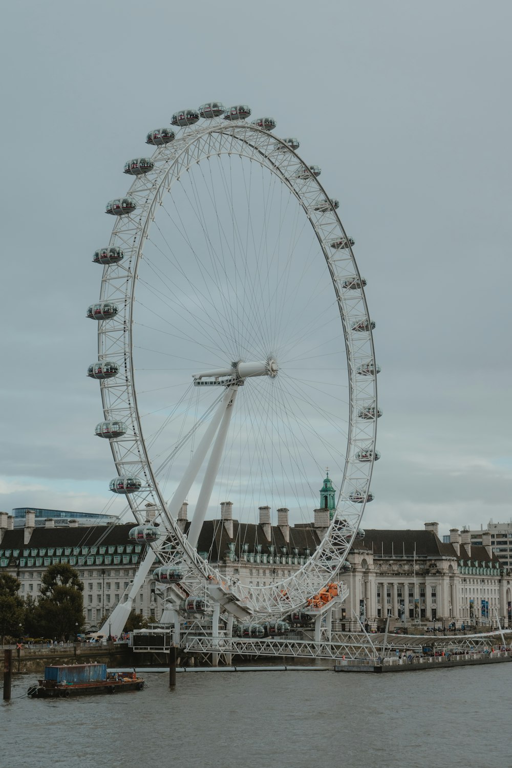 a large ferris wheel sitting in the middle of a body of water