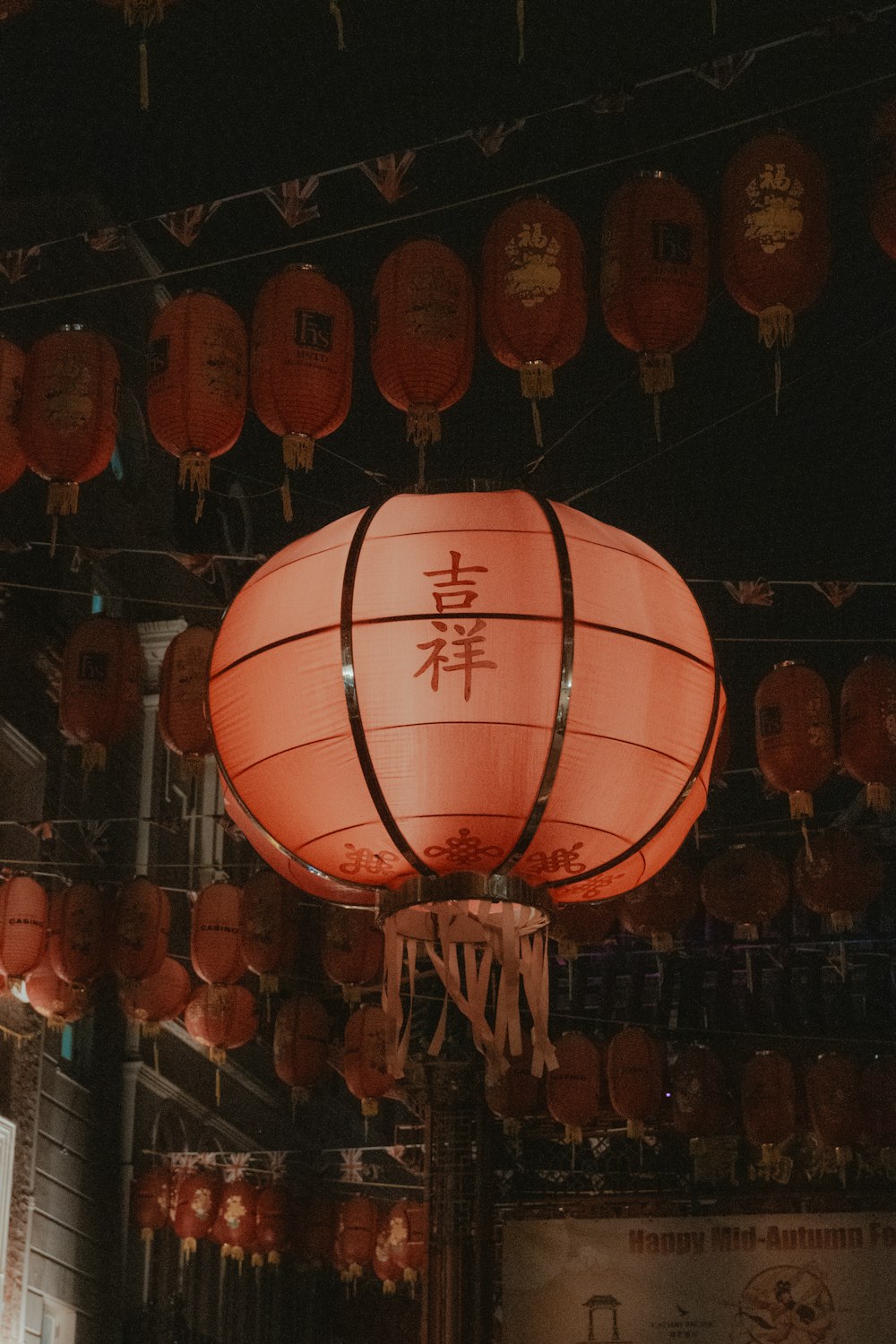 a large red lantern hanging from a ceiling