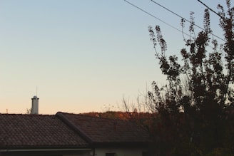 A beautifully restored rooftop overlooking a serene natural landscape at sunset.